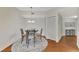 Cozy dining area with seating for four, chandelier, and decorative rug at 5459 Bentgrass Dr # 2-304, Sarasota, FL 34235