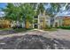 Inviting condo building exterior featuring manicured landscaping and ample parking at 5459 Bentgrass Dr # 2-304, Sarasota, FL 34235