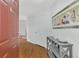Inviting foyer with wood floors, grey shelving, and a decorative painting at 5459 Bentgrass Dr # 2-304, Sarasota, FL 34235