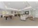 Spacious game room featuring a billiards table, comfortable seating, and a bar area at 5459 Bentgrass Dr # 2-304, Sarasota, FL 34235
