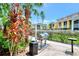 Community grilling area with stainless steel grills, trash receptacles and lush landscaping at 5459 Bentgrass Dr # 2-304, Sarasota, FL 34235