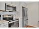Modern kitchen with stainless steel appliances and white cabinets at 5459 Bentgrass Dr # 2-304, Sarasota, FL 34235
