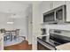 Modern kitchen with stainless steel appliances, white cabinets, and hardwood floors at 5459 Bentgrass Dr # 2-304, Sarasota, FL 34235