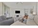 Bright living room with neutral decor, balcony access and hardwood floors at 5459 Bentgrass Dr # 2-304, Sarasota, FL 34235
