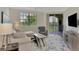 Relaxing living room with comfortable seating and sliding door access to a balcony at 5459 Bentgrass Dr # 2-304, Sarasota, FL 34235