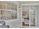 View from the screened lanai into the condo's bright living space and kitchen at 5459 Bentgrass Dr # 2-304, Sarasota, FL 34235