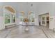 Bright lobby with arched windows, tiled floors, elegant furnishings and a welcoming floral display at 5459 Bentgrass Dr # 2-304, Sarasota, FL 34235
