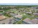 A residential area with well-kept homes, green lawns, screened in pools, and mature trees at 5828 Lincoln Rd, Venice, FL 34293