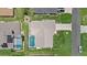 Aerial shot of a home with a private pool, manicured lawn, and a spacious driveway at 5828 Lincoln Rd, Venice, FL 34293