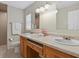 Bright bathroom featuring a double vanity, ample counter space, and neutral wall color at 5828 Lincoln Rd, Venice, FL 34293