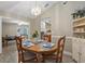 Charming dining room with stylish chandelier, open to kitchen, and natural light at 5828 Lincoln Rd, Venice, FL 34293