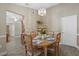 Cozy dining room featuring a chandelier, wood floors, and a kitchen view at 5828 Lincoln Rd, Venice, FL 34293
