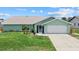 Charming single-story home with a well-manicured lawn, and a two-car garage at 5828 Lincoln Rd, Venice, FL 34293