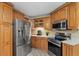 Well-equipped kitchen featuring stainless steel appliances, custom wood cabinets at 5828 Lincoln Rd, Venice, FL 34293