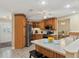 Bright kitchen with stainless steel appliances, breakfast bar, and wood cabinetry at 5828 Lincoln Rd, Venice, FL 34293