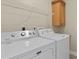 Functional laundry room with a washer, dryer, shelf, and ample counter space at 5828 Lincoln Rd, Venice, FL 34293