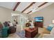 Comfortable living room featuring beamed ceilings, tile floors and cozy furniture at 5828 Lincoln Rd, Venice, FL 34293