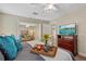Serene main bedroom featuring a comfy bed, access to the living room, and TV at 5828 Lincoln Rd, Venice, FL 34293