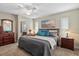Inviting primary bedroom with soft carpet, fan, en-suite bath, and a large window at 5828 Lincoln Rd, Venice, FL 34293