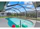 Screened-in pool area, perfect for relaxation, features a refreshing pool, and a spacious deck at 5828 Lincoln Rd, Venice, FL 34293