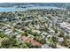 Expansive aerial view of a residential area showing the tile roofs, proximity to a bay, and neighborhood layout at 609 Madrid Ave, Venice, FL 34285