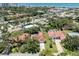 An aerial view highlights the terracotta roof and proximity to the beach and ocean at 609 Madrid Ave, Venice, FL 34285