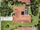 Aerial view of a well-maintained home with a screened pool, lush lawn and terracotta tiled roof at 609 Madrid Ave, Venice, FL 34285