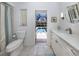 Bright bathroom with new fixtures and a view to the screened-in pool outside at 609 Madrid Ave, Venice, FL 34285