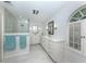 Elegant bathroom featuring double sinks, quartz countertops and glass shower at 609 Madrid Ave, Venice, FL 34285