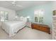 Comfortable bedroom with a large bed, ceiling fan, and lots of natural light at 609 Madrid Ave, Venice, FL 34285