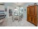 Cozy breakfast nook with a glass table, wicker chairs, and natural light at 609 Madrid Ave, Venice, FL 34285