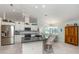 Bright, open kitchen with stainless steel appliances, granite countertops, and a breakfast bar with seating at 609 Madrid Ave, Venice, FL 34285