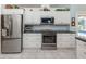 Modern kitchen featuring stainless steel appliances, sleek countertops, and ample cabinet space for storage at 609 Madrid Ave, Venice, FL 34285
