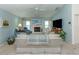 Spacious living room featuring a fireplace, light blue walls, tile floors and neutral furniture at 609 Madrid Ave, Venice, FL 34285