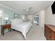 Comfortable main bedroom with soft carpet, bright windows and access to patio at 609 Madrid Ave, Venice, FL 34285