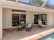 Covered patio with an outdoor dining area and views of the pool at 609 Madrid Ave, Venice, FL 34285