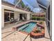 Screened pool with a tile and brick border, perfect for relaxing and entertaining at 609 Madrid Ave, Venice, FL 34285