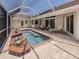 Private, screened-in pool with a brick paver patio, perfect for outdoor entertaining at 609 Madrid Ave, Venice, FL 34285