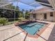 Tranquil screened-in pool with a waterfall feature and landscaped surroundings at 609 Madrid Ave, Venice, FL 34285