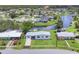 Waterfront living with canal access, featuring lush landscaping, and modern architecture in a serene lakeside neighborhood at 6821 Marius Rd, North Port, FL 34287