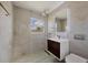 Updated bathroom featuring marble-style tiling, a floating vanity, and a glass-enclosed shower with modern fixtures at 6821 Marius Rd, North Port, FL 34287