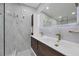 Modern bathroom features double sinks, marble walls, and elegant fixtures at 6821 Marius Rd, North Port, FL 34287