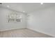 Bright bedroom with modern flooring, white walls, and a large window at 6821 Marius Rd, North Port, FL 34287