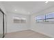 Clean bedroom featuring modern windows, and neutral walls and flooring for a versatile living space at 6821 Marius Rd, North Port, FL 34287