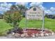 Welcome to Marius Park sign with colorful flowers and lush landscaping at 6821 Marius Rd, North Port, FL 34287