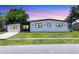 Charming home with a well-manicured lawn, modern design, and enhanced curb appeal for a comfortable living experience at 6821 Marius Rd, North Port, FL 34287