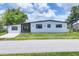 Charming home with manicured lawn, modern design, and enhanced curb appeal for a comfortable living experience at 6821 Marius Rd, North Port, FL 34287