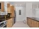 Well-designed kitchen featuring wood-look cabinets, black countertops, stainless steel appliances, and modern lighting at 6821 Marius Rd, North Port, FL 34287