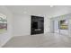 Spacious living room with a black marble fireplace and sliding glass doors to the backyard at 6821 Marius Rd, North Port, FL 34287