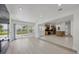 Spacious open-concept living area connects to the kitchen and features sliding glass doors at 6821 Marius Rd, North Port, FL 34287